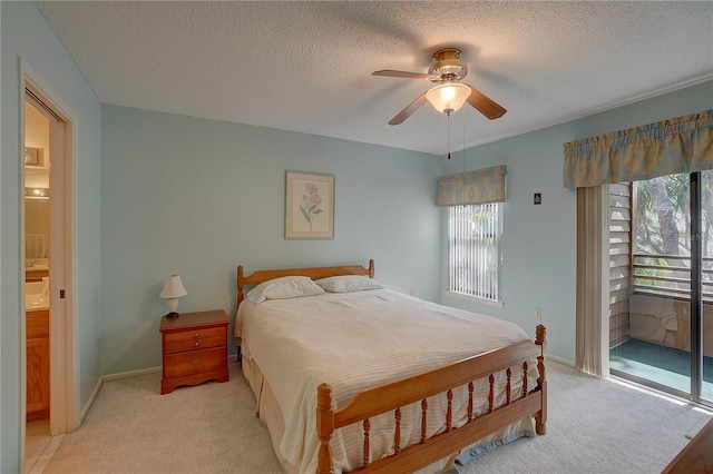 carpeted bedroom featuring ceiling fan and a textured ceiling