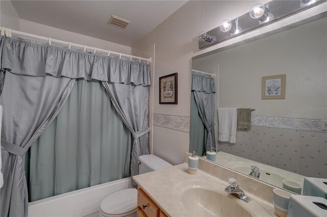 full bathroom featuring vanity, toilet, and shower / bath combo with shower curtain