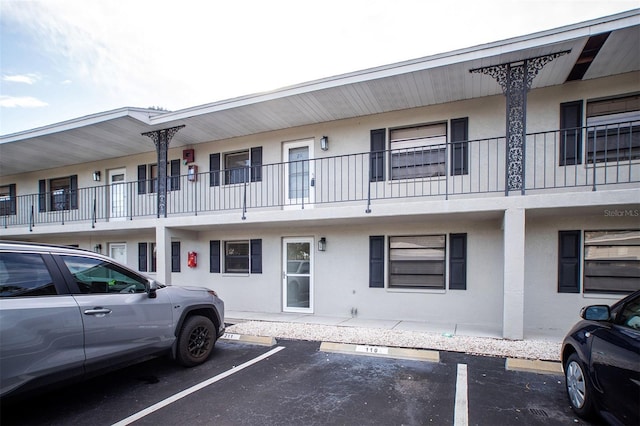 view of building exterior featuring uncovered parking