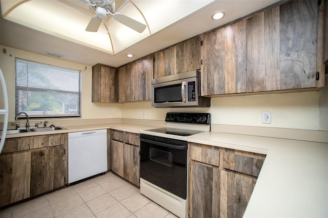 kitchen featuring sink, ceiling fan, white appliances, and light tile patterned floors