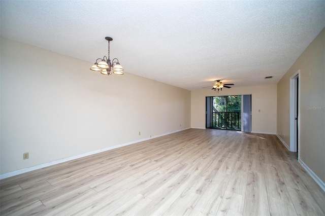 unfurnished room with ceiling fan with notable chandelier, a textured ceiling, and light wood-type flooring