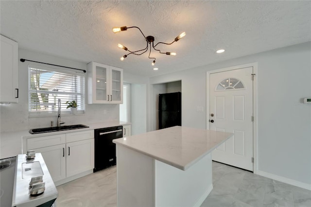 kitchen with a center island, white cabinets, sink, black dishwasher, and a chandelier