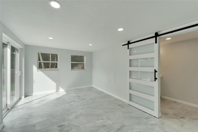 spare room featuring a barn door