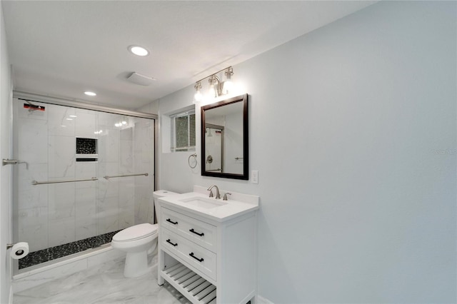 bathroom with vanity, toilet, and a shower with door