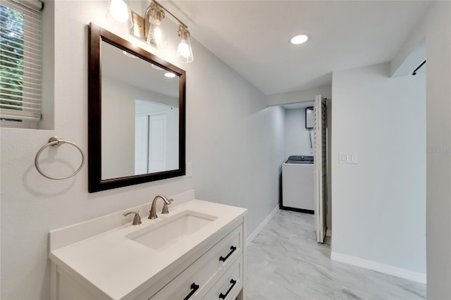 bathroom featuring vanity and washer / dryer