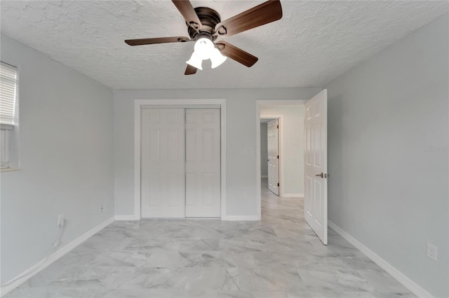 unfurnished bedroom with a textured ceiling, a closet, and ceiling fan