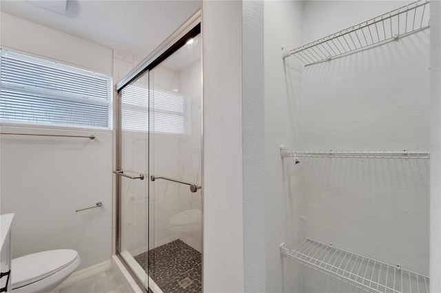 bathroom with walk in shower and toilet