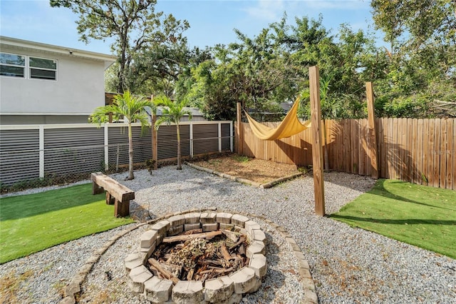 view of yard with a fire pit