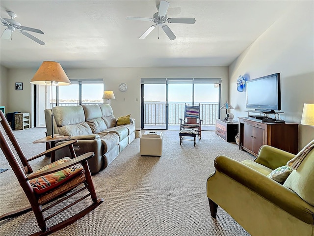 living room featuring a wealth of natural light, light colored carpet, a textured ceiling, and ceiling fan