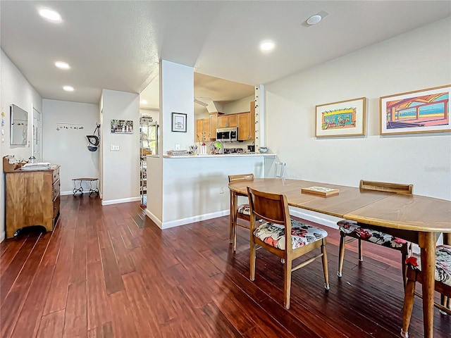 dining space with recessed lighting, dark wood finished floors, and baseboards