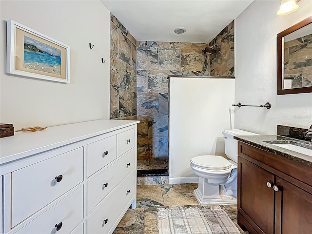 full bathroom featuring toilet, walk in shower, vanity, and stone tile floors