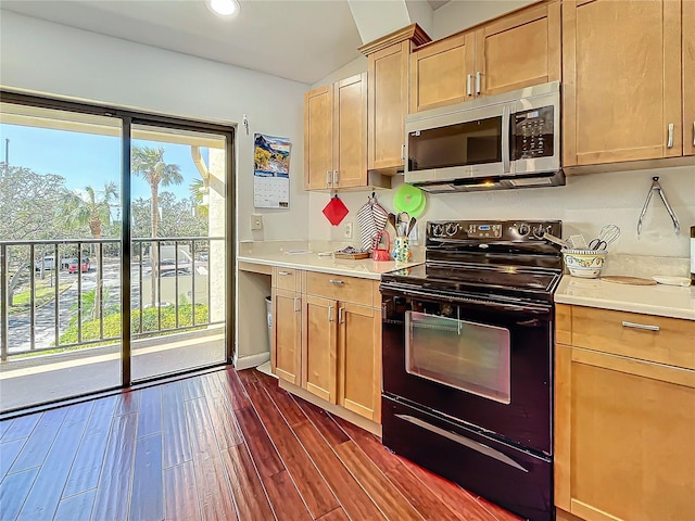 kitchen featuring light countertops, electric range, stainless steel microwave, and dark wood-style flooring