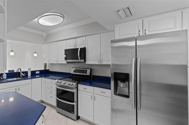 kitchen with white cabinets, light tile patterned floors, ornamental molding, sink, and stainless steel appliances