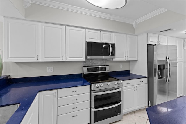 kitchen featuring crown molding, appliances with stainless steel finishes, white cabinetry, and light tile patterned floors