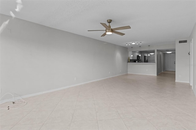 unfurnished living room featuring a textured ceiling, light tile patterned flooring, and ceiling fan