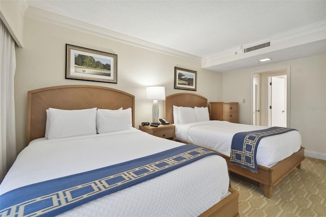 bedroom featuring ornamental molding and a textured ceiling