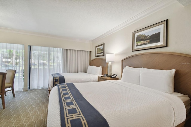 carpeted bedroom featuring ornamental molding and a textured ceiling