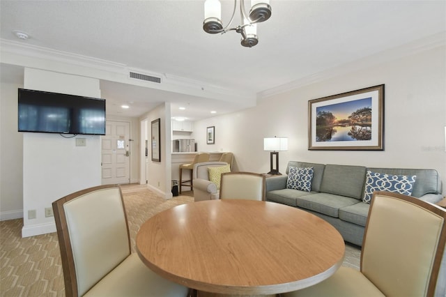 dining area featuring light carpet, crown molding, and a chandelier