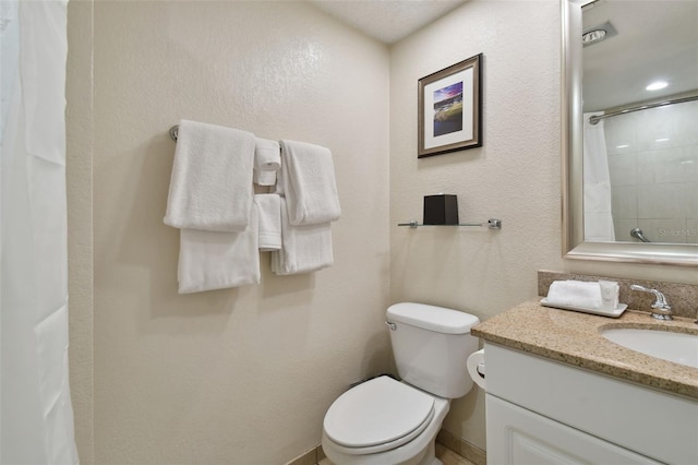 bathroom with vanity, curtained shower, and toilet