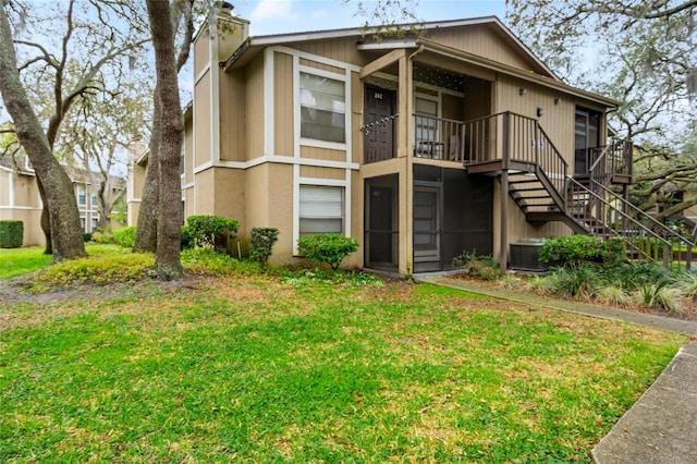 14323 Hanging Moss Cir Unit 102, Tampa, FL 33613 - view of front of home featuring a front yard, stairs, central air condition unit, and a chimney