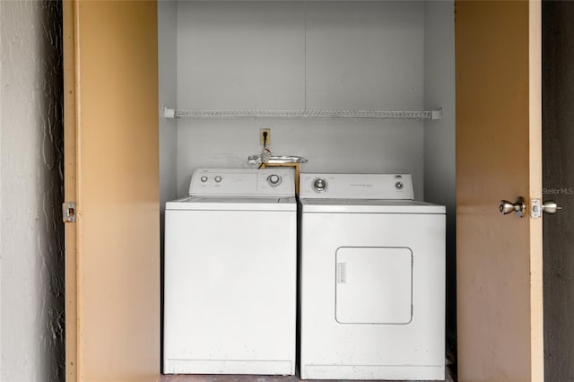 clothes washing area featuring washing machine and clothes dryer