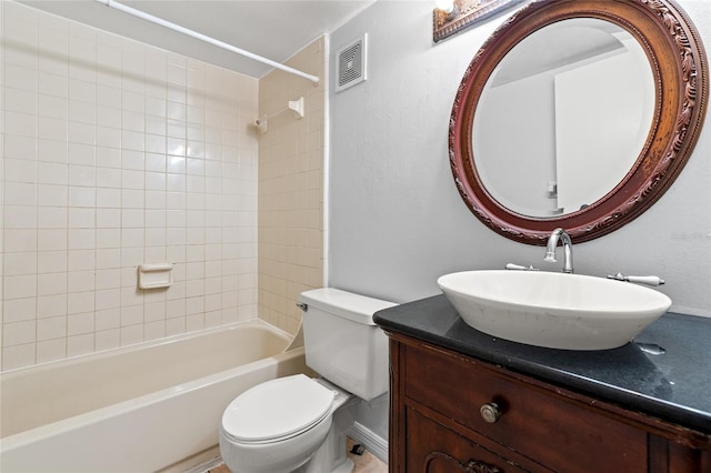 full bathroom with vanity, toilet, and tiled shower / bath