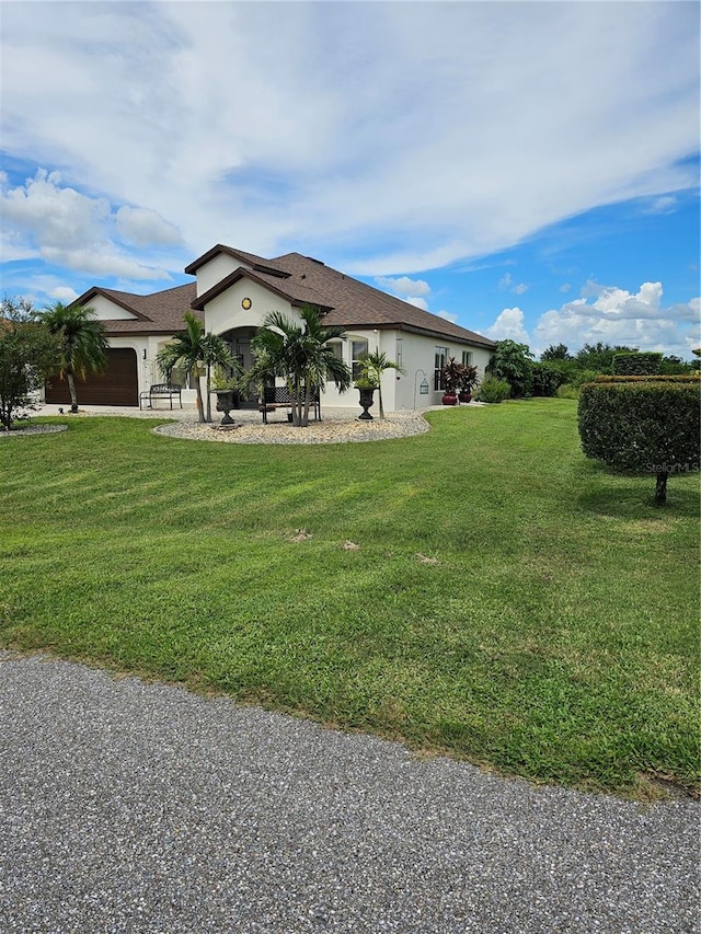 view of side of home with a yard and a garage