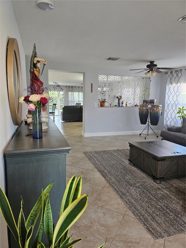 living room featuring ceiling fan and light tile patterned floors