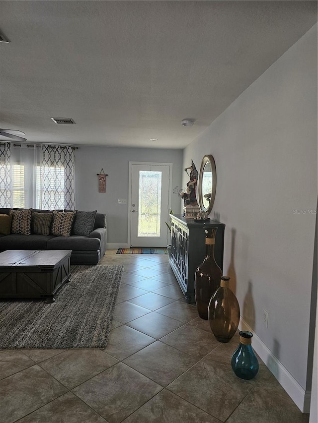 tiled living room with a textured ceiling