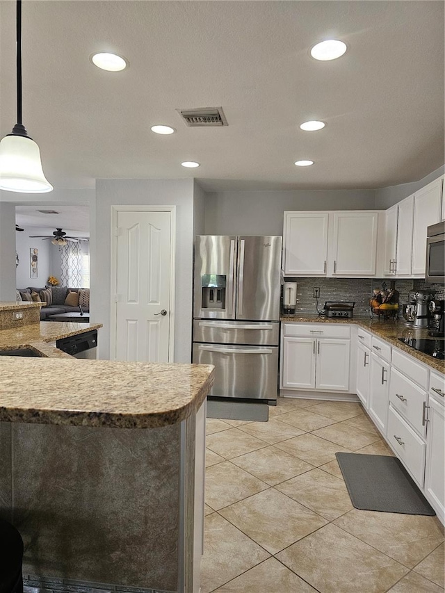 kitchen with decorative light fixtures, decorative backsplash, white cabinetry, and stainless steel appliances