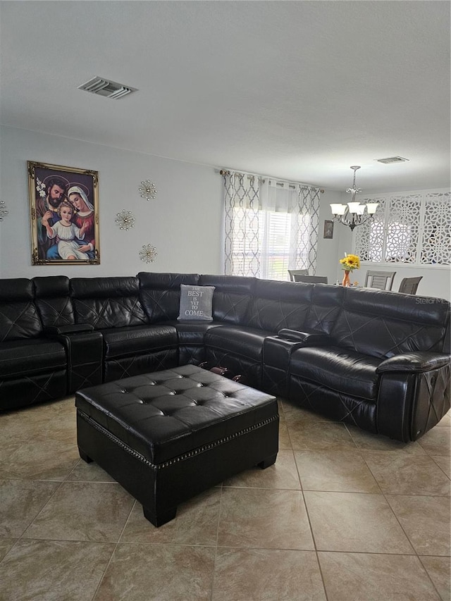 tiled living room with a notable chandelier