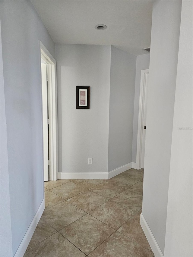 hallway with light tile patterned floors