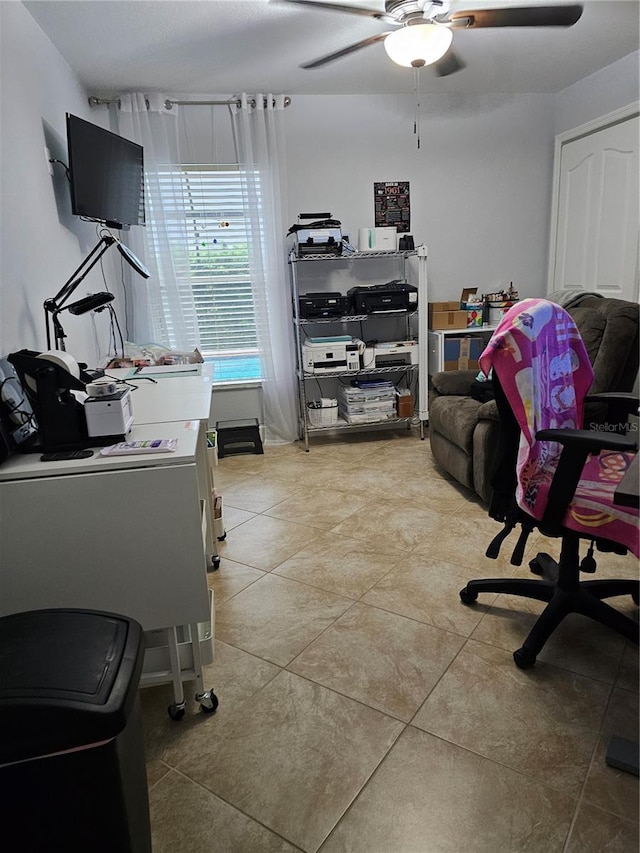 office featuring light tile patterned floors and ceiling fan