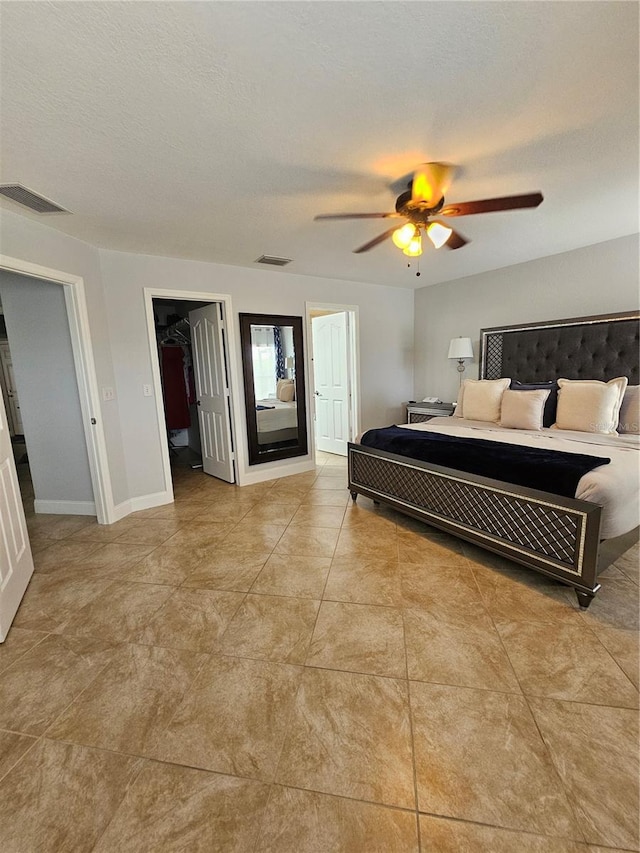 bedroom with a textured ceiling, a closet, and ceiling fan