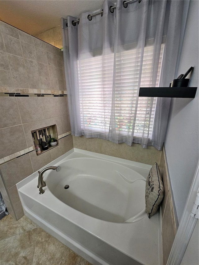 bathroom featuring a tub to relax in and tile patterned floors