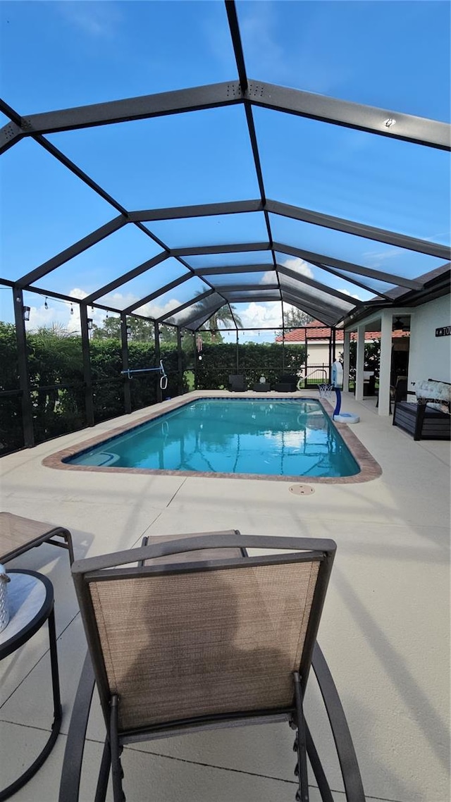 view of swimming pool with a lanai and a patio area