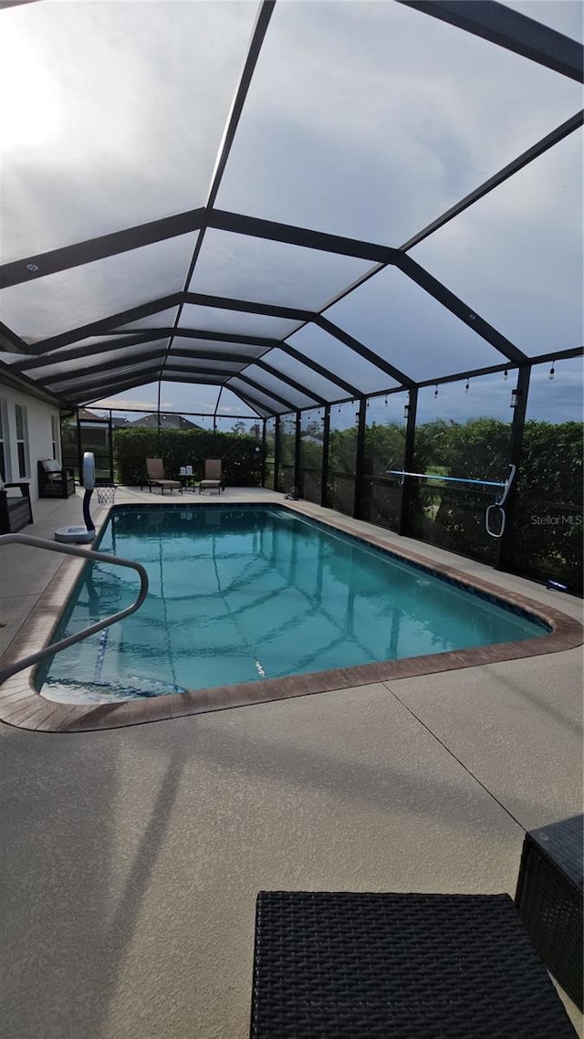 view of pool featuring a patio area and a lanai