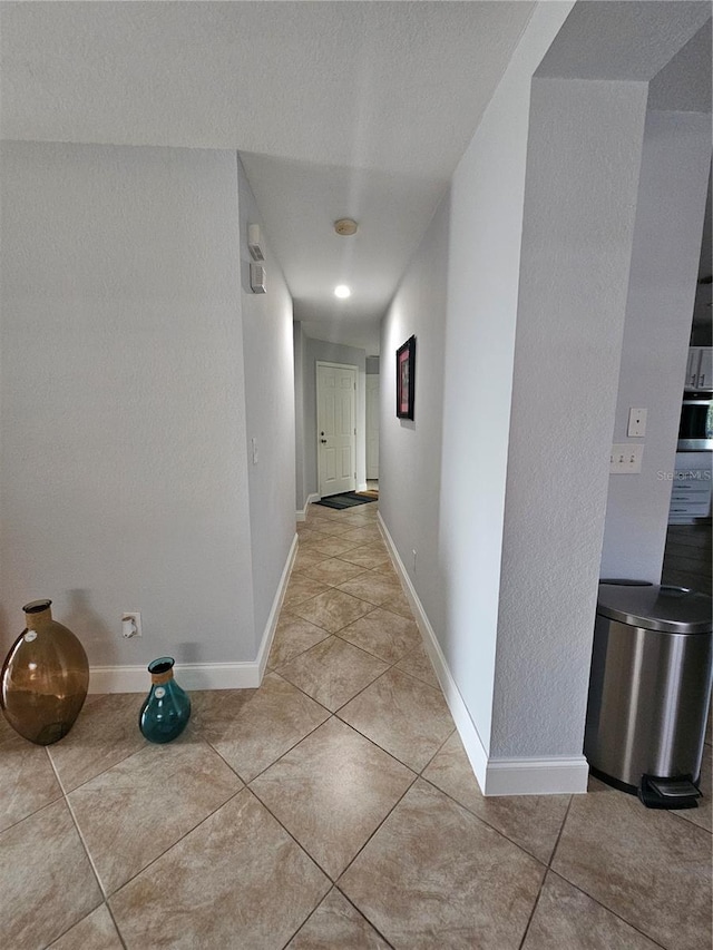 corridor featuring light tile patterned flooring