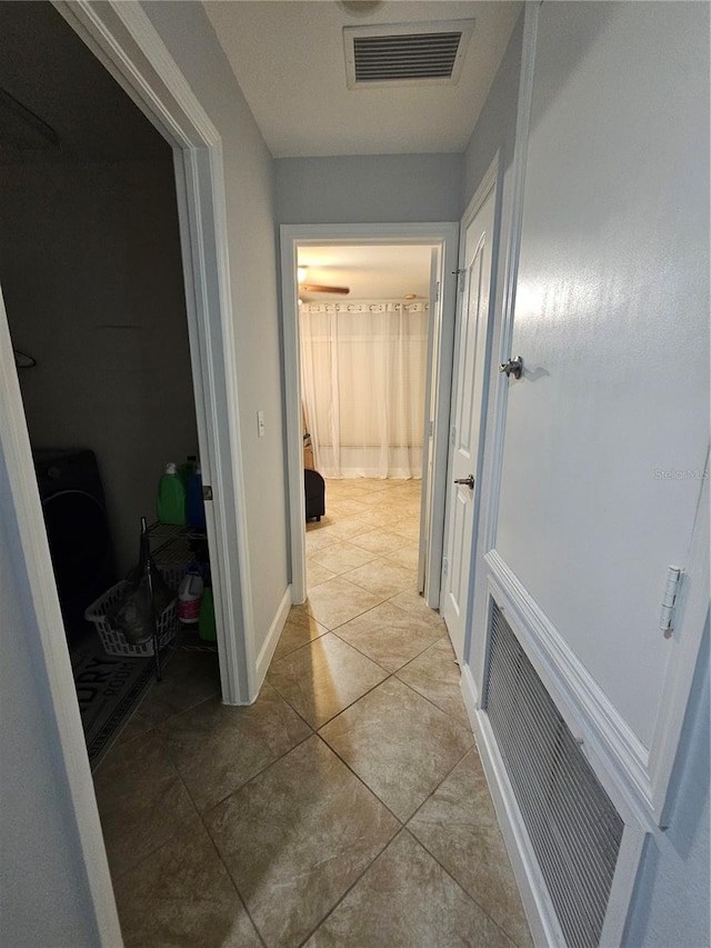 corridor with light tile patterned floors