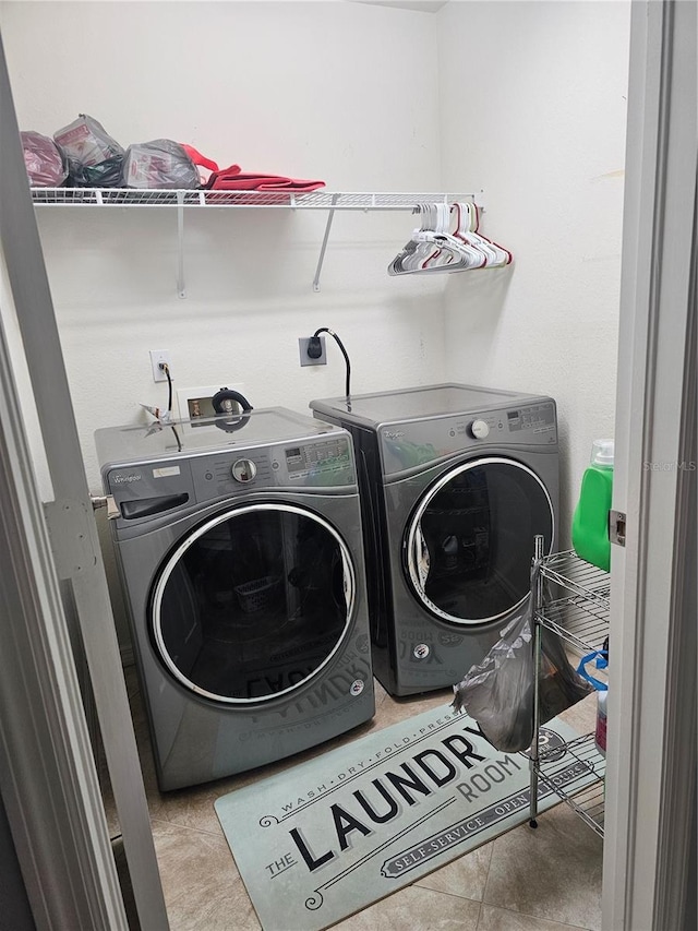 laundry room with light tile patterned flooring and independent washer and dryer