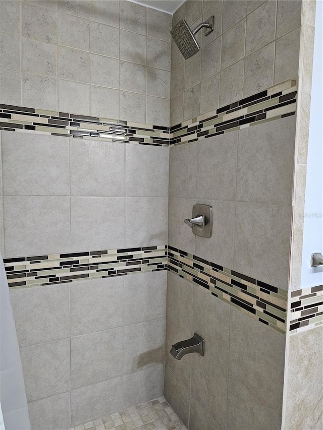 bathroom with tiled shower