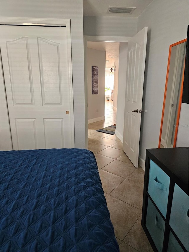 tiled bedroom featuring a closet