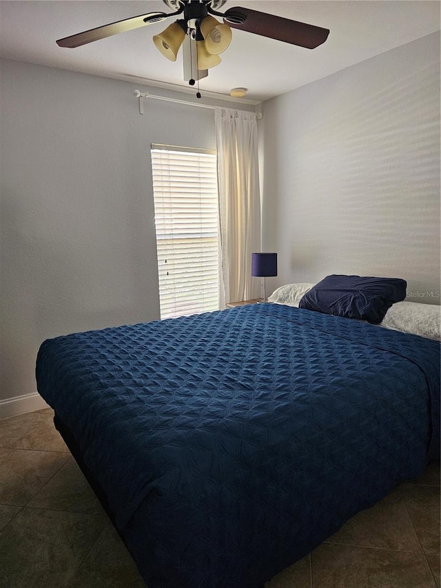 tiled bedroom with ceiling fan