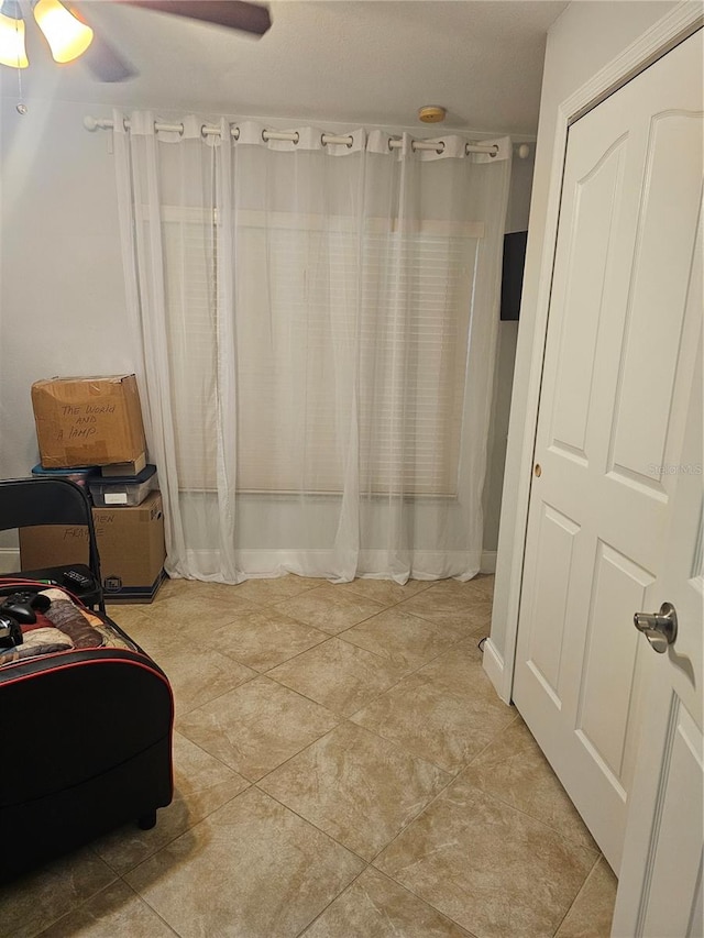 bathroom featuring tile patterned flooring and ceiling fan