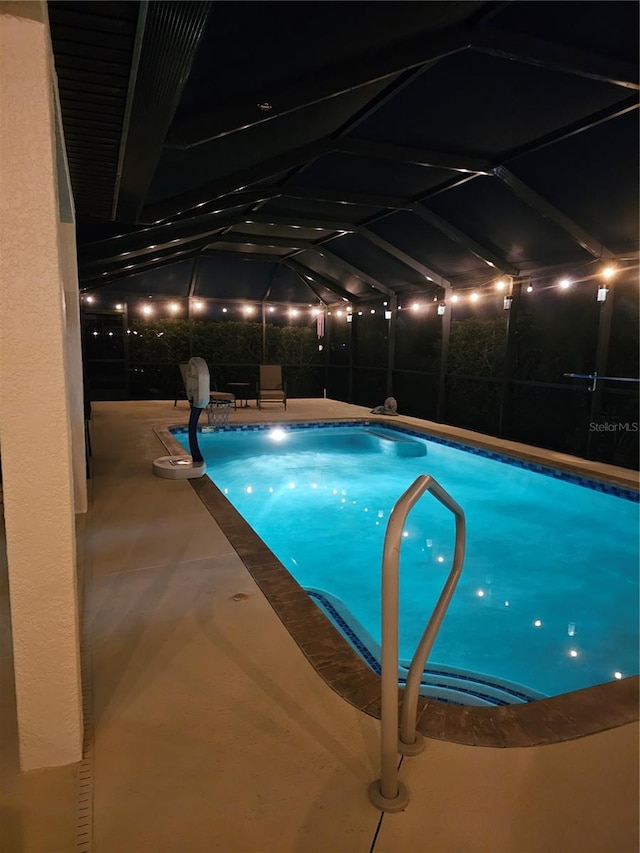 view of swimming pool with a lanai and a patio