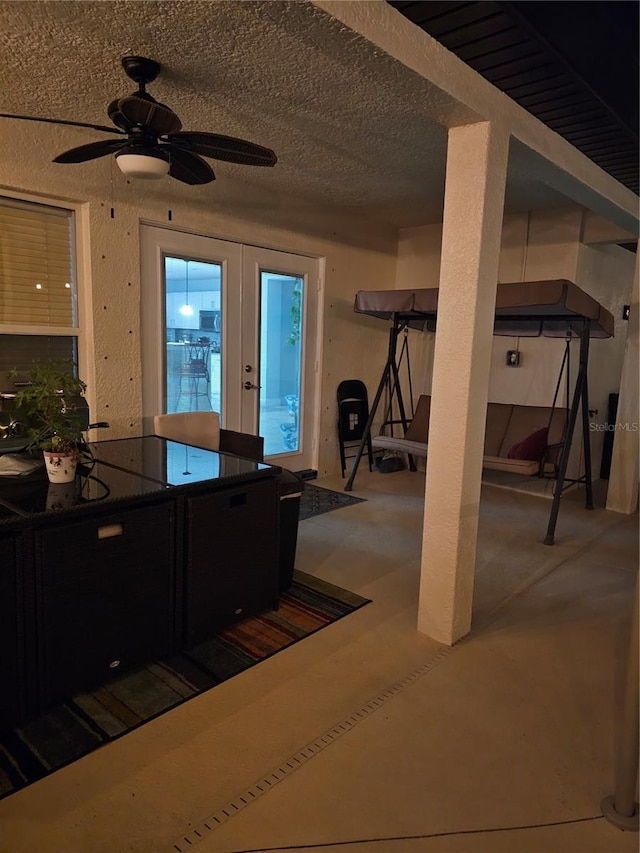 kitchen featuring ceiling fan, a textured ceiling, and french doors