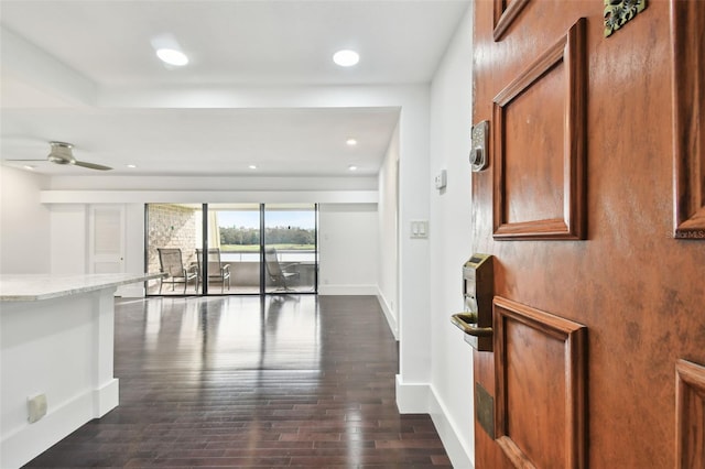interior space with recessed lighting, baseboards, and dark wood-type flooring