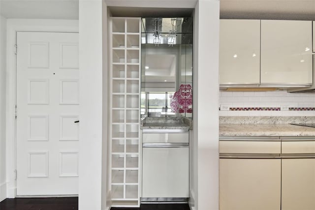 details with light stone counters, tasteful backsplash, and a chandelier