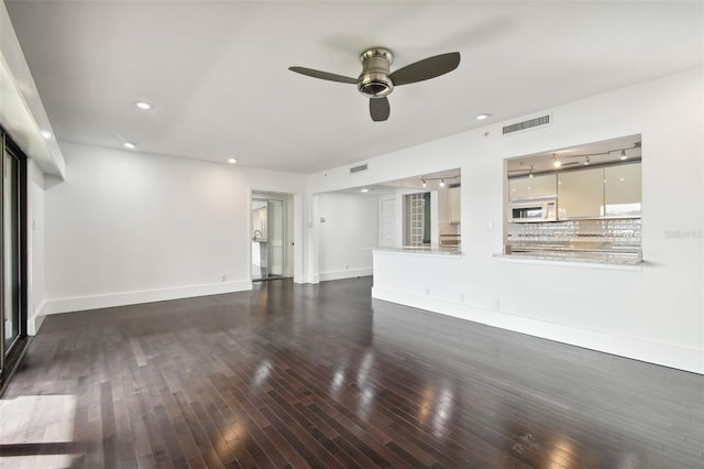 unfurnished living room featuring baseboards, ceiling fan, hardwood / wood-style flooring, and visible vents