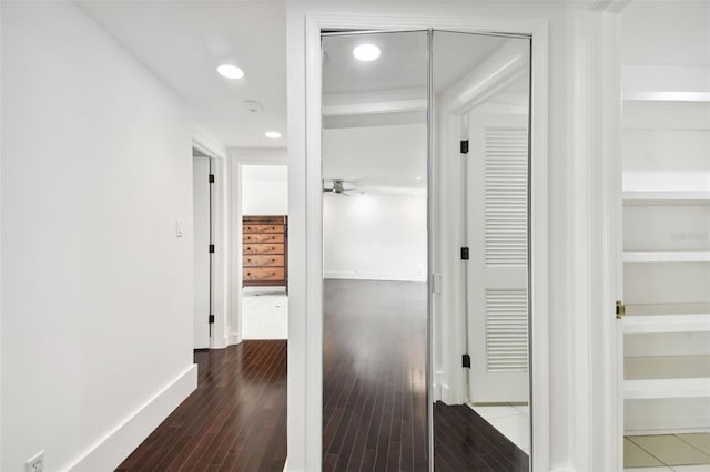 hall featuring recessed lighting, baseboards, and wood finished floors